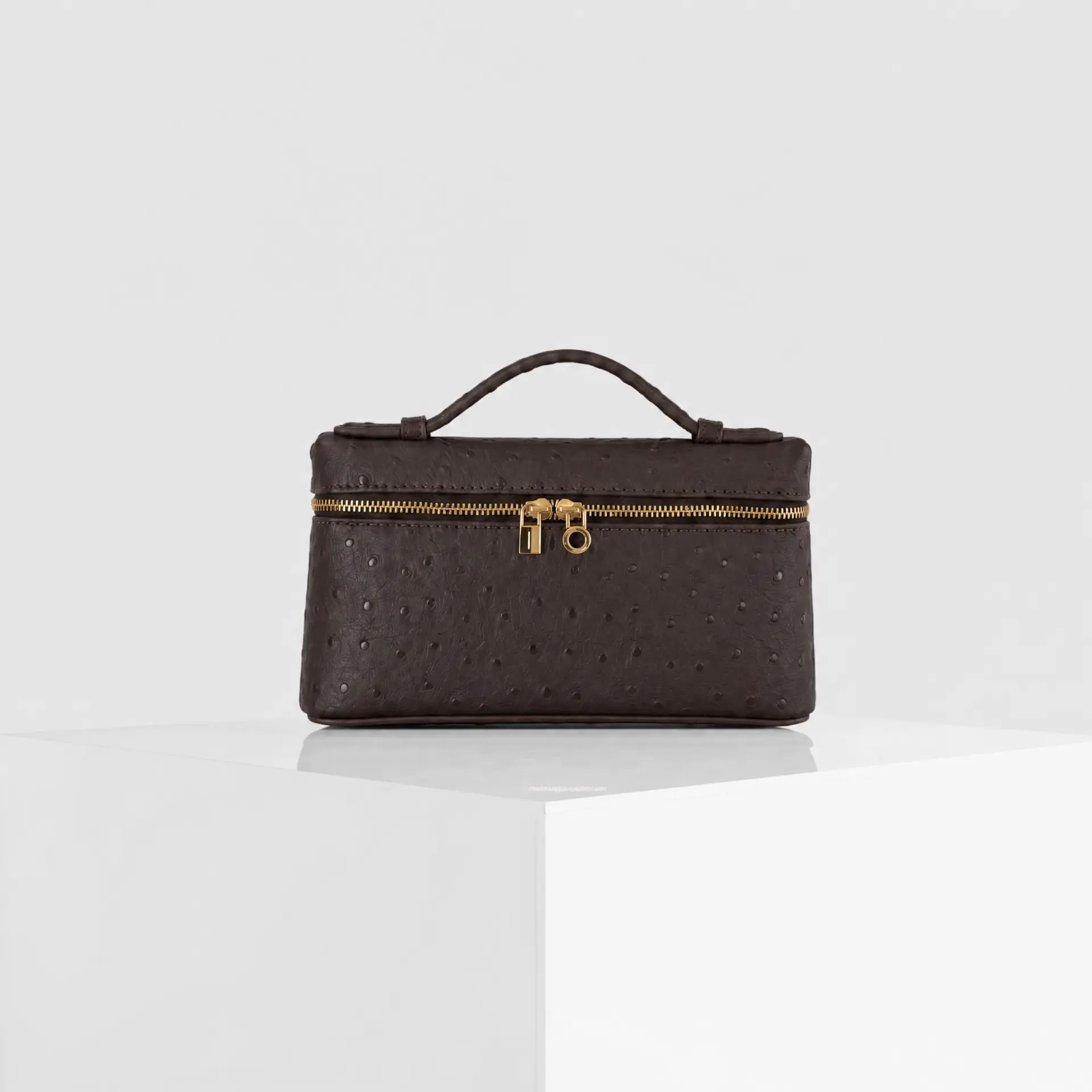 Dark brown cocoa ostrich-embossed top-handle mini case bag with gold hardware