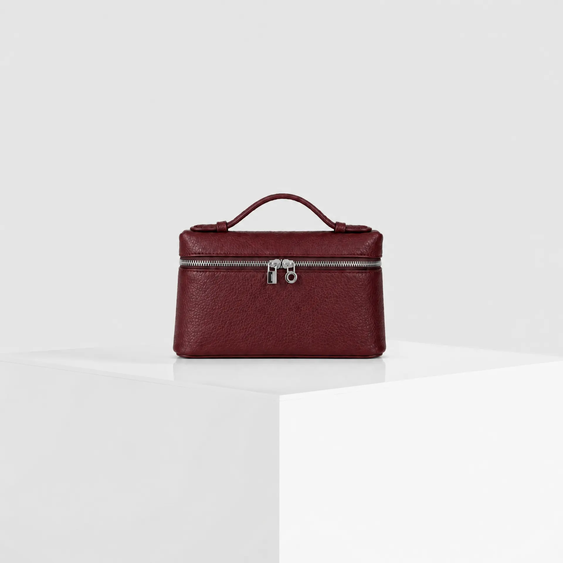 Burgundy red pebbled leather top-handle mini case bag with silver hardware