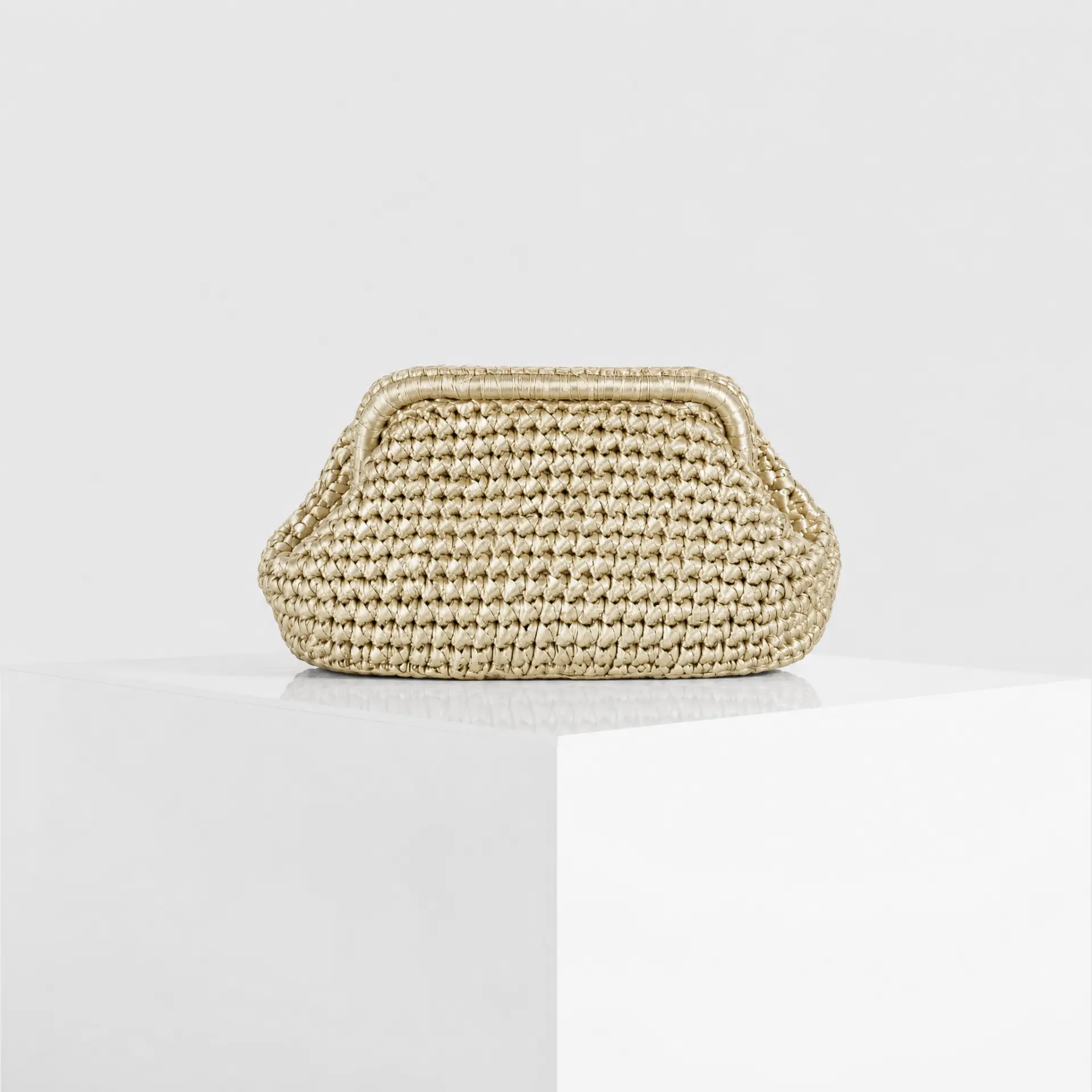 Hand-crocheted raffia cloud clutch in champagne gold