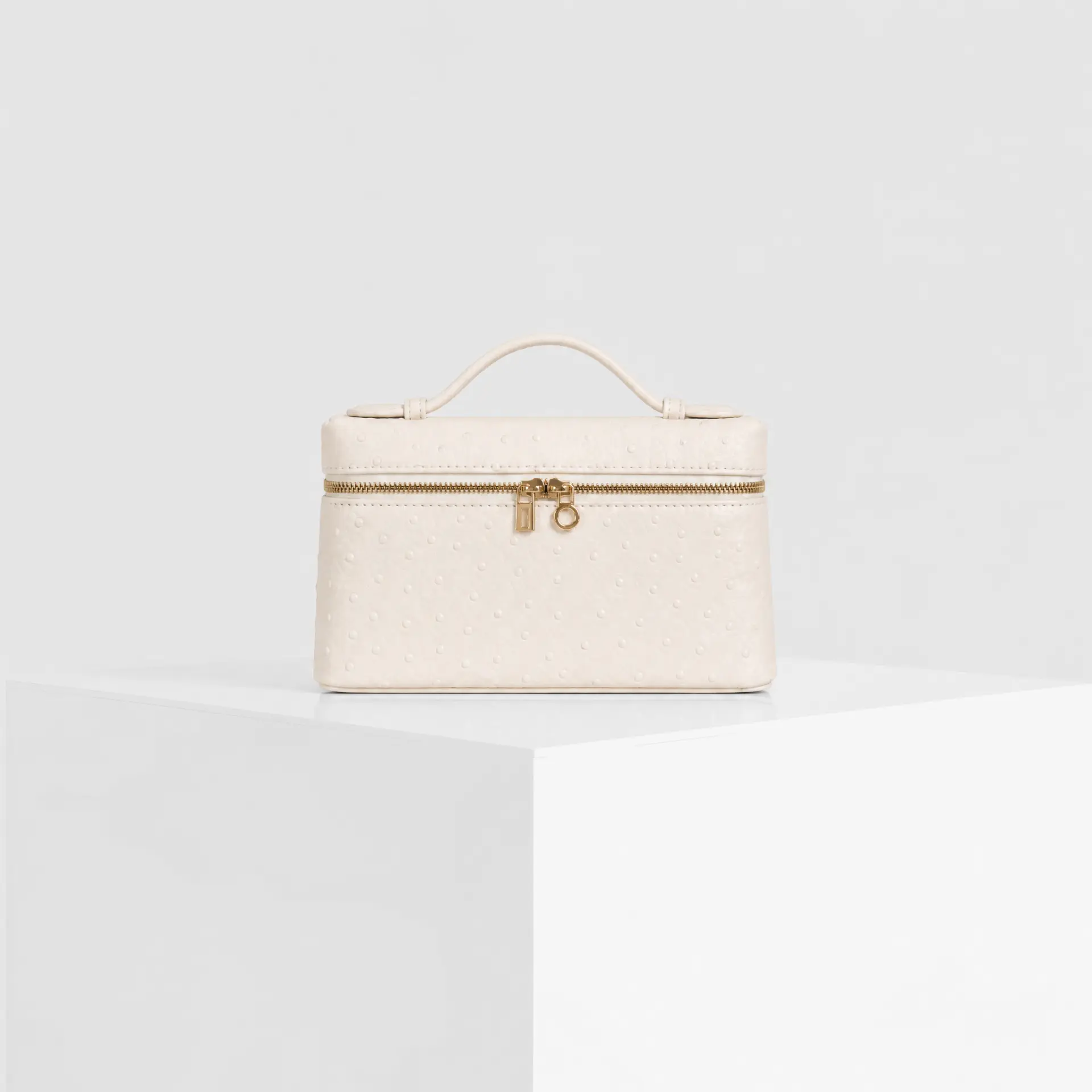 Cream ivory ostrich-embossed top-handle mini case bag with gold hardware