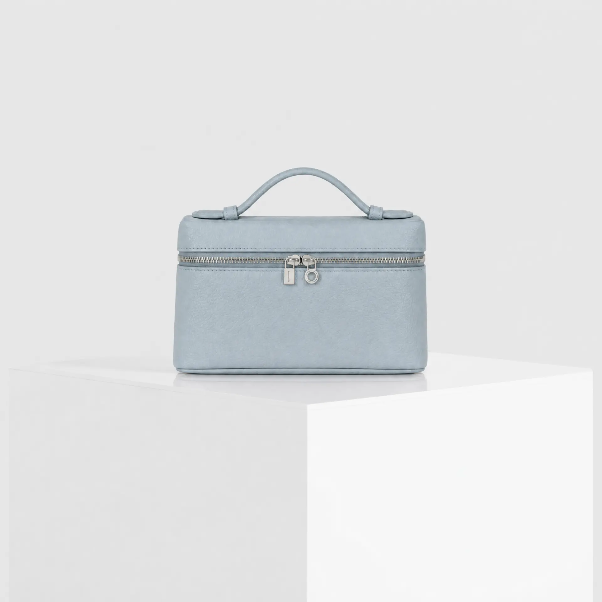 Light blue sky pebbled leather top-handle mini case bag with silver hardware