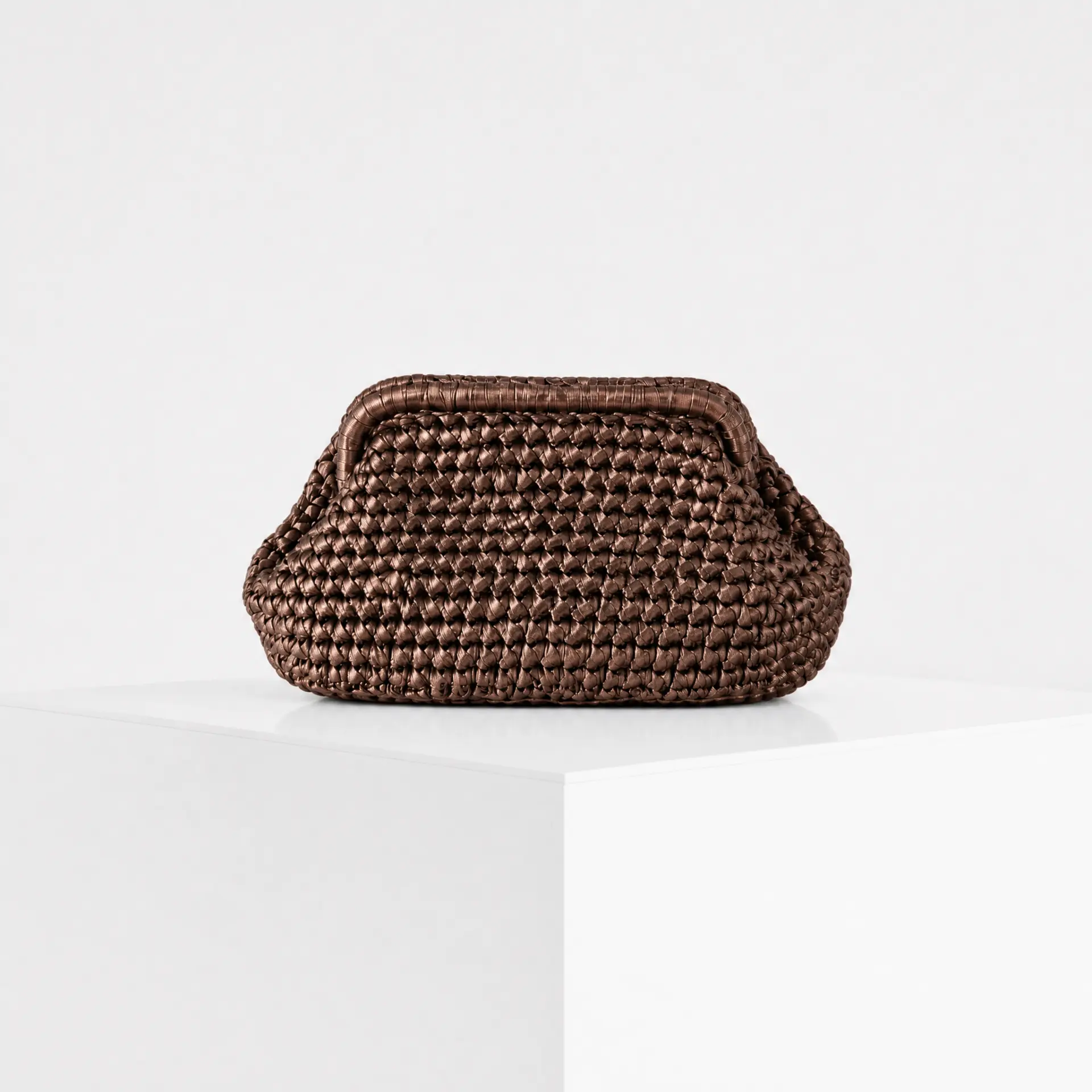 Hand-crocheted raffia cloud clutch in metallic bronze
