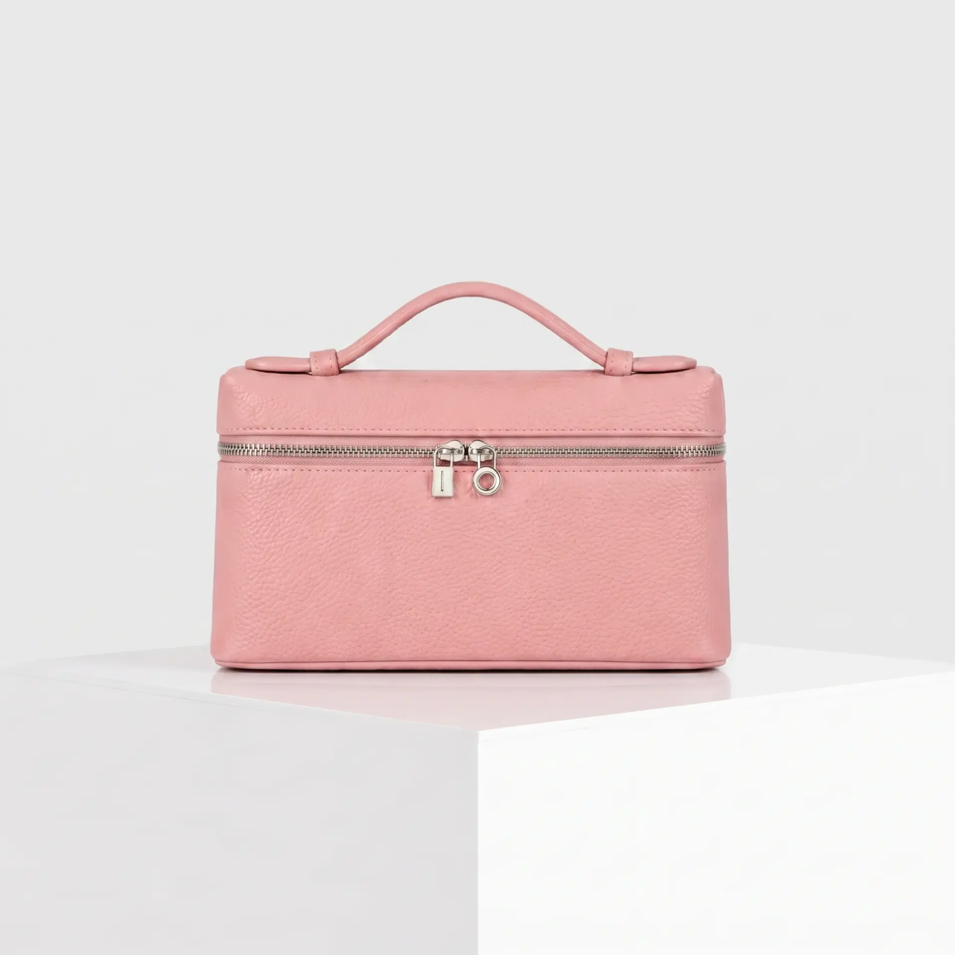Soft blush pink pebbled leather top-handle mini case bag with silver hardware
