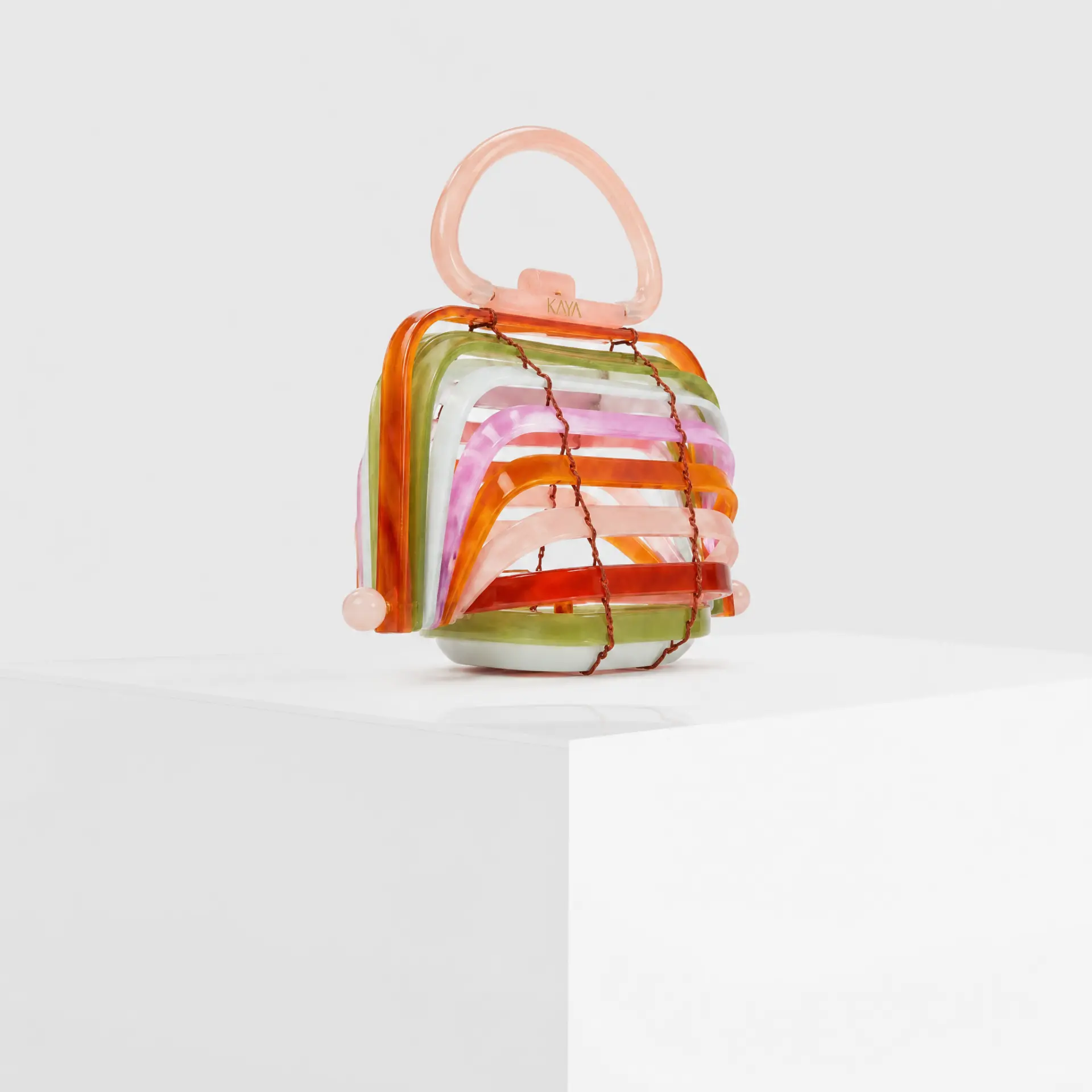 Collapsible rainbow acrylic cage clutch with rose-gold top handle and pearl feet