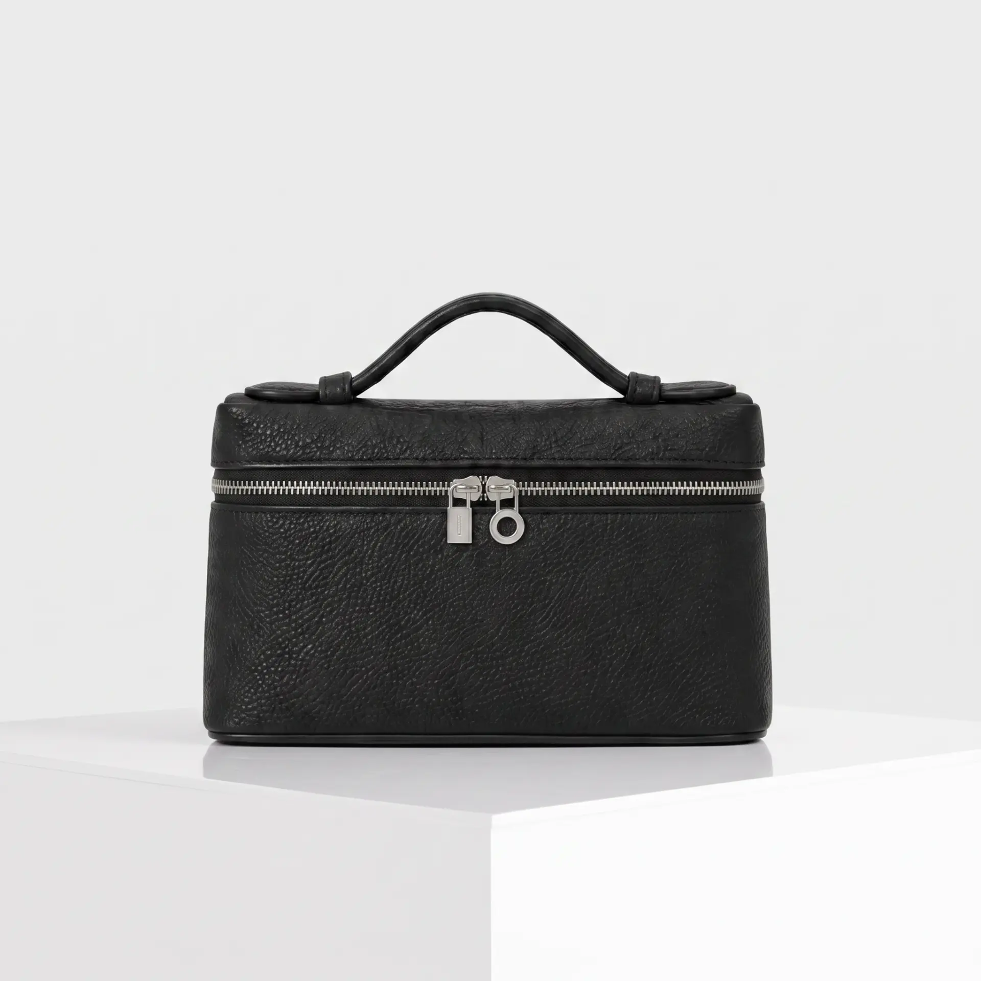 Black pebbled leather top-handle mini case bag with silver wrap-around zipper